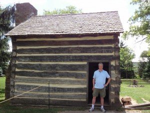 silly photo of Bob, the blogger, in front of a small rustic cabin